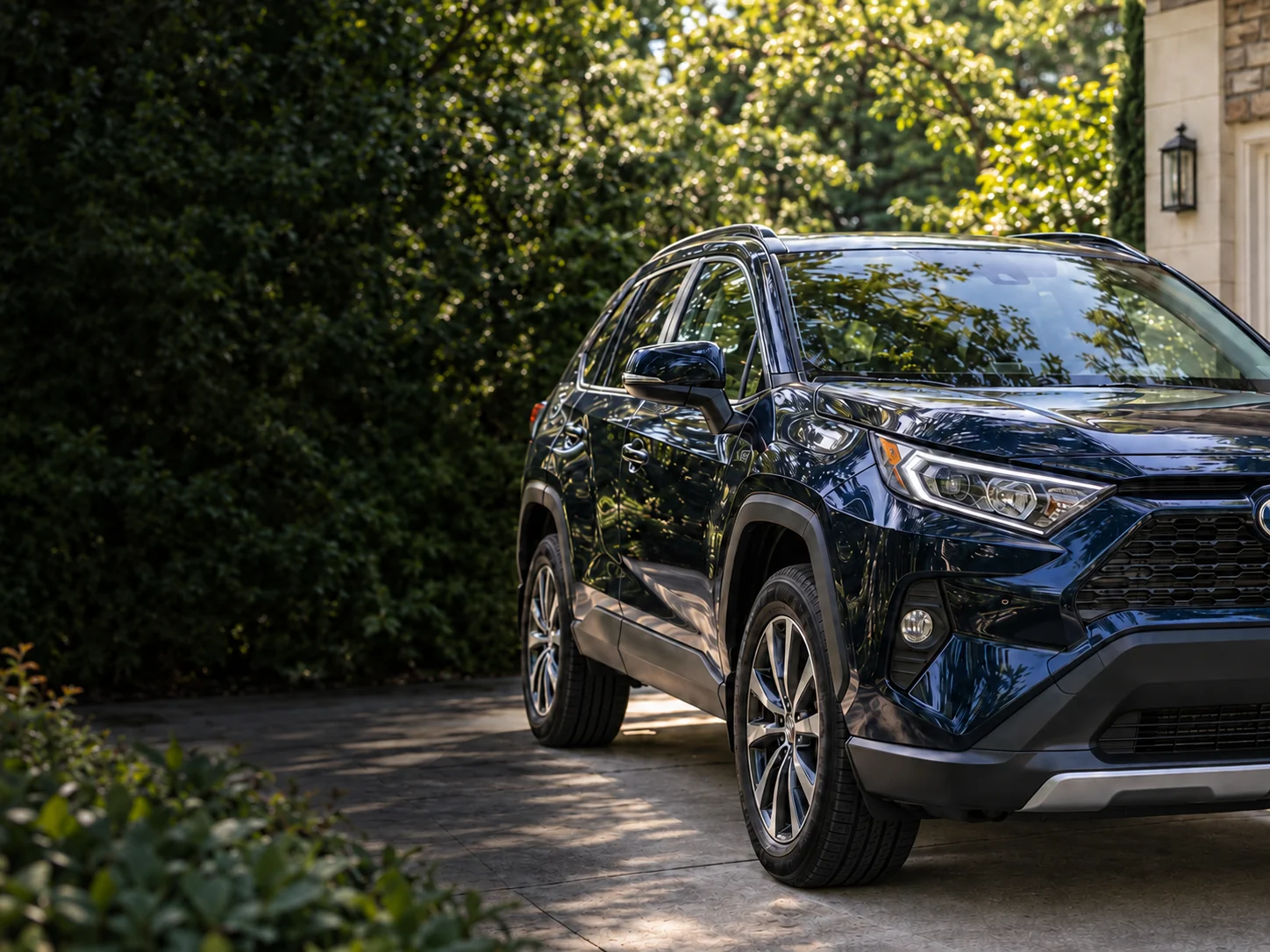 Illustrative photograph of a clean blue family crossover in a residential driveway