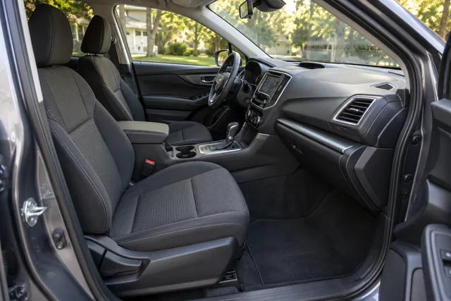 Clean dark cloth seats, dashboard and floor in a family crossover